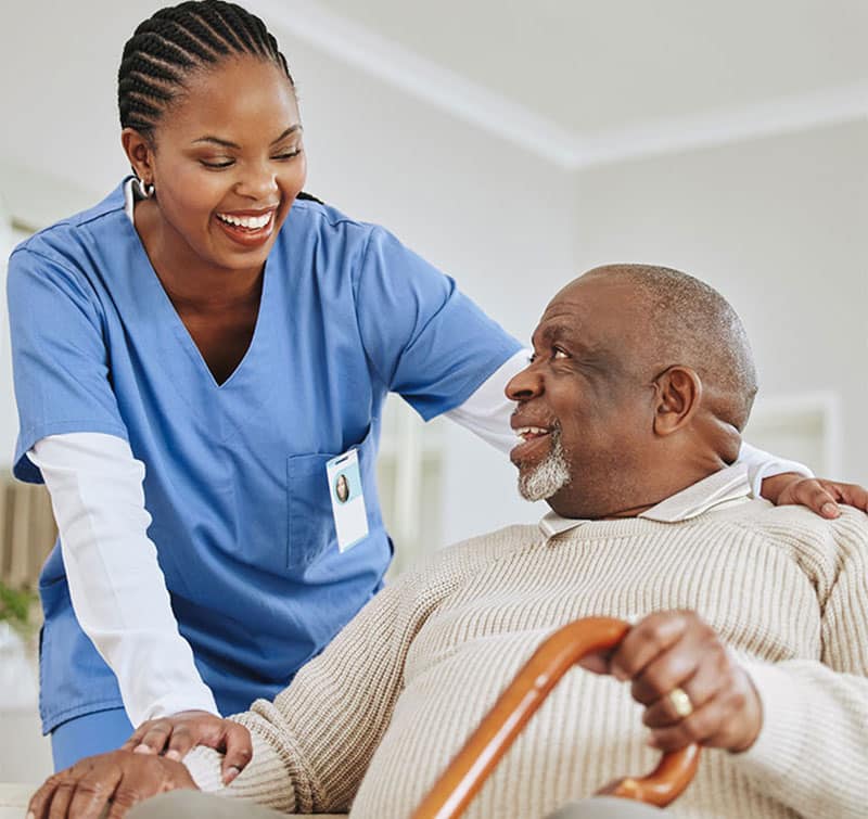 Nurse talking to man holding cane